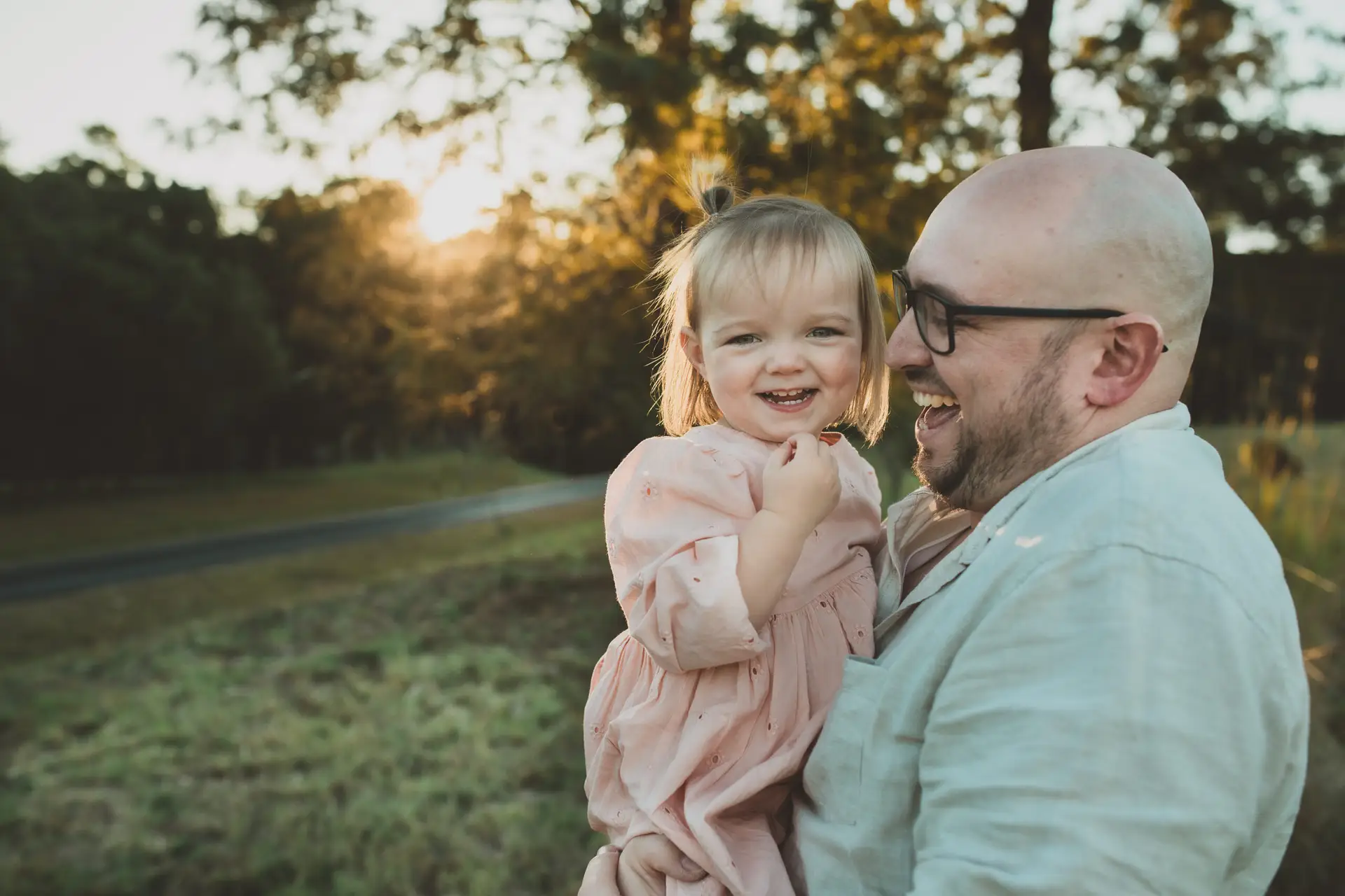 Child laughing at sunset family session