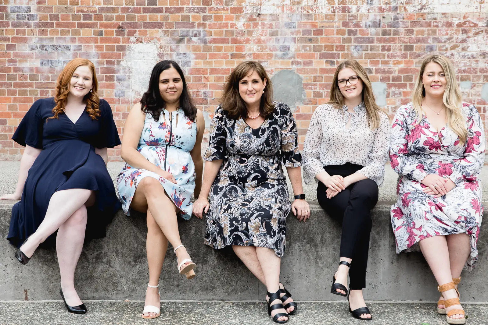 Marketing Agency employees sit on a step